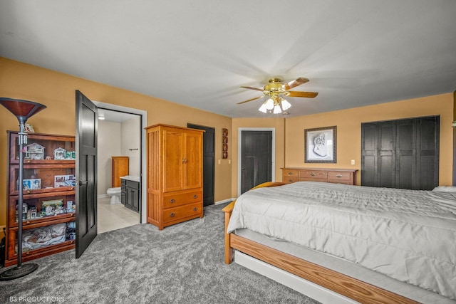 carpeted bedroom with ceiling fan and ensuite bathroom