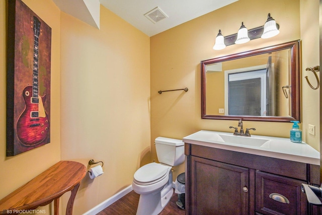 bathroom featuring vanity, toilet, and wood-type flooring