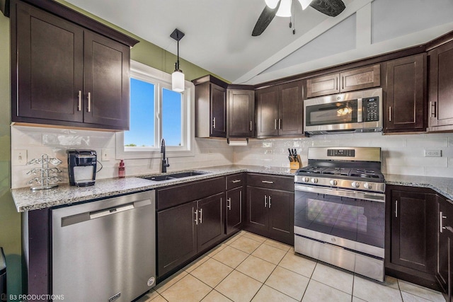 kitchen with dark brown cabinetry, sink, stainless steel appliances, and vaulted ceiling