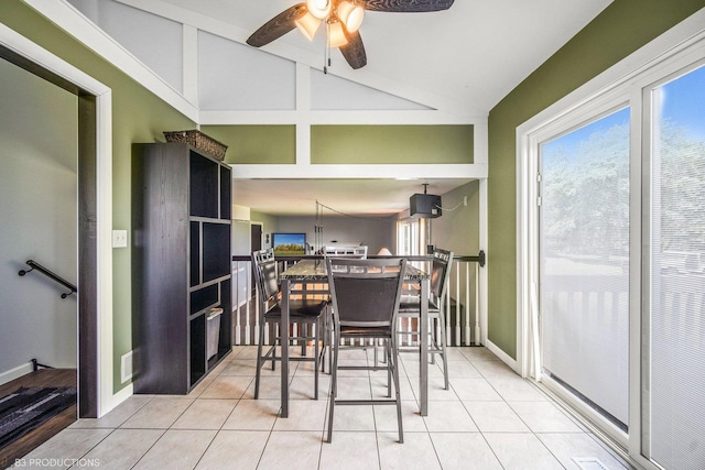 dining space featuring ceiling fan, light tile patterned floors, and lofted ceiling