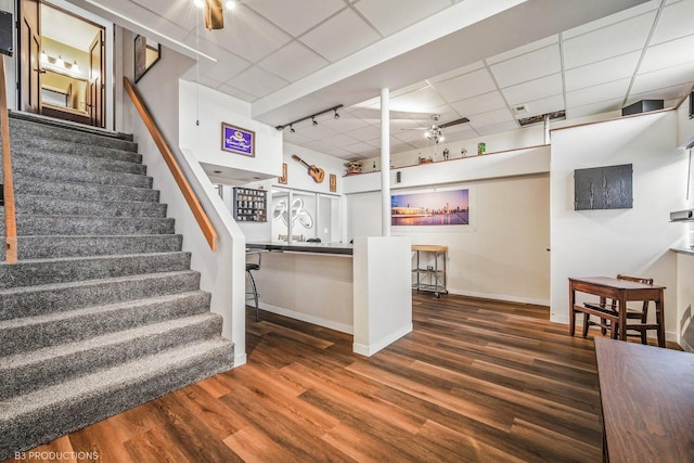 staircase featuring hardwood / wood-style flooring and a paneled ceiling