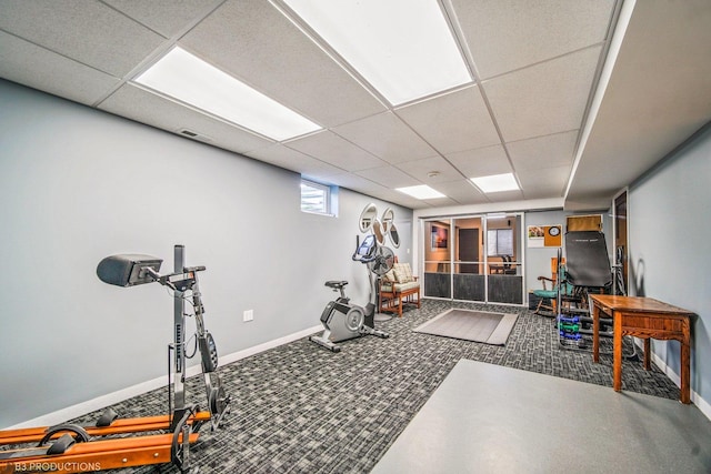 workout room featuring a drop ceiling and carpet