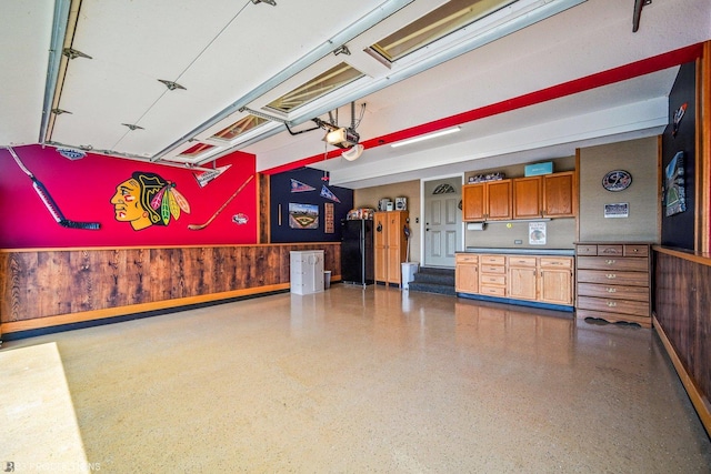 garage with wooden walls and a garage door opener