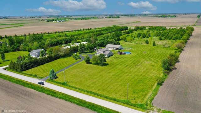 birds eye view of property with a rural view