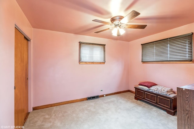 unfurnished bedroom with ceiling fan and light carpet