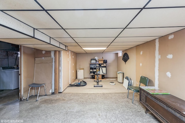 basement featuring a paneled ceiling and washer / dryer