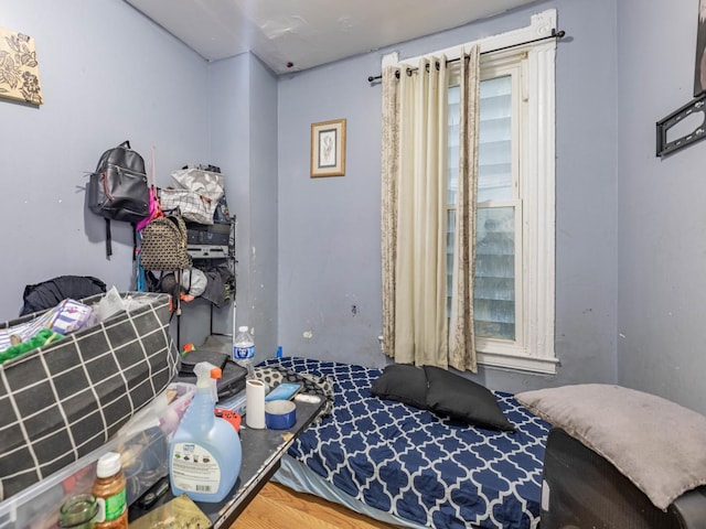 bedroom with hardwood / wood-style flooring