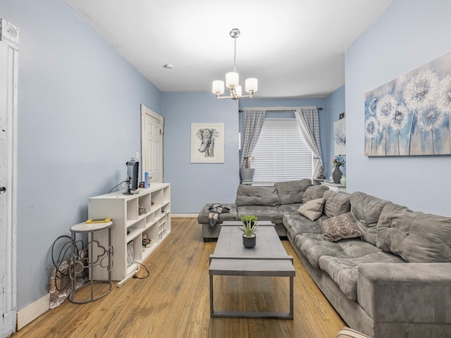 living room with a chandelier and light wood-type flooring