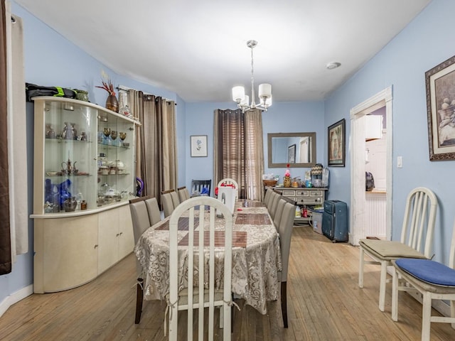 dining room featuring light hardwood / wood-style floors and an inviting chandelier