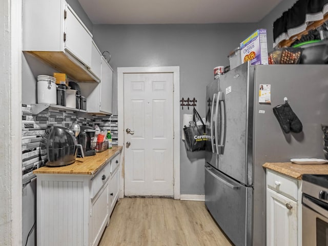 kitchen featuring decorative backsplash, stainless steel range, white cabinets, and light wood-type flooring