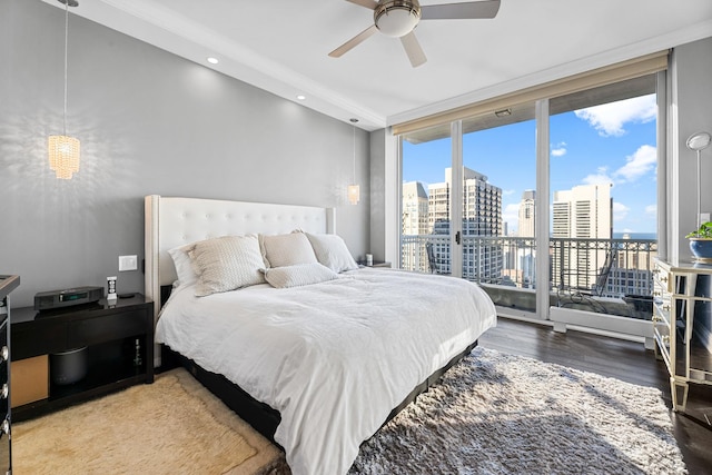 bedroom featuring hardwood / wood-style flooring, ceiling fan, floor to ceiling windows, and access to exterior