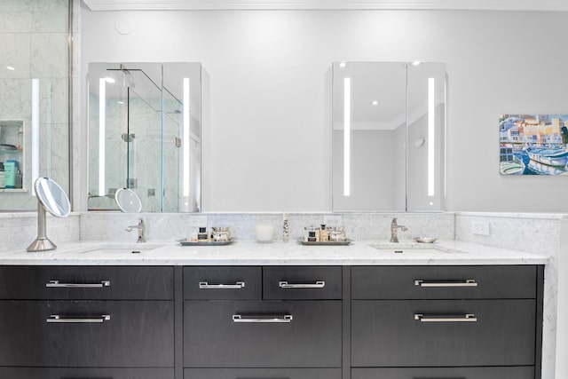 bathroom with vanity, an enclosed shower, and crown molding