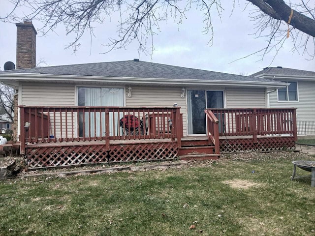 back of house with a yard and a deck