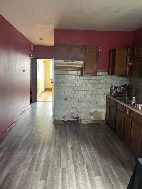 kitchen featuring decorative backsplash and light hardwood / wood-style flooring