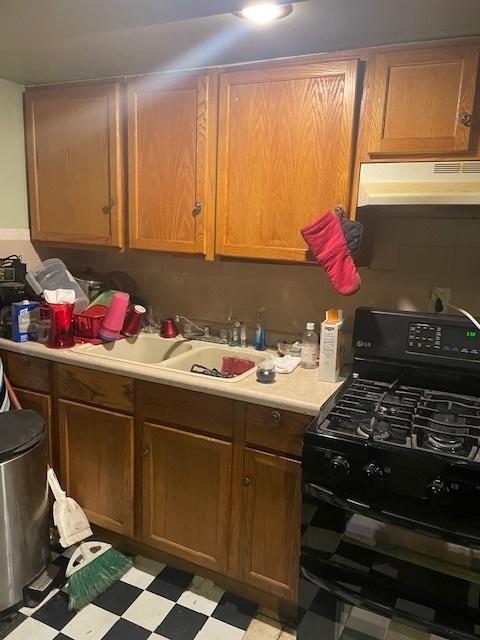 kitchen featuring sink, black range with gas cooktop, and range hood