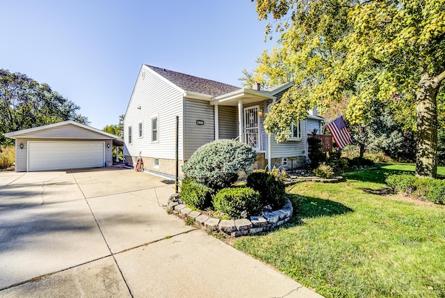 view of front of home featuring an outbuilding, a front lawn, and a garage