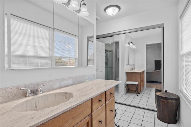 bathroom with tile patterned floors, vanity, and an enclosed shower