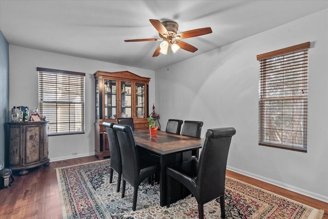 dining space featuring dark hardwood / wood-style floors and ceiling fan