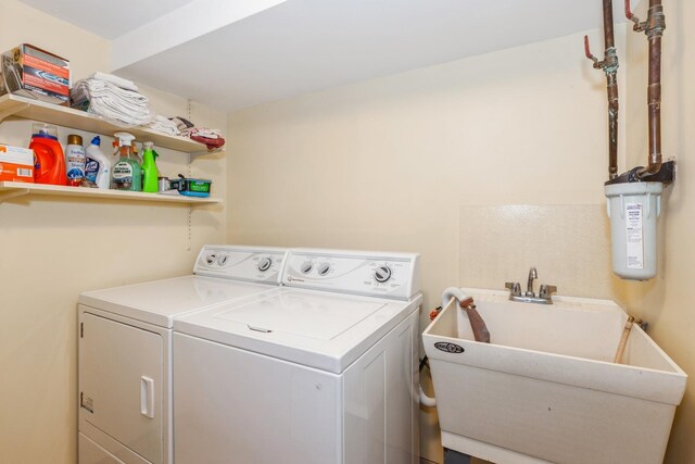 laundry room with a sink, independent washer and dryer, and laundry area