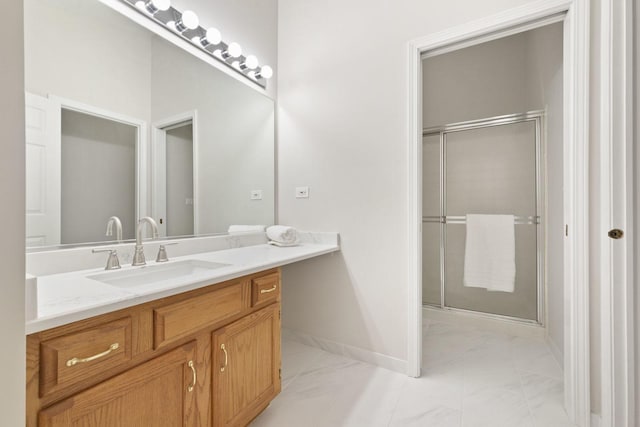 bathroom with vanity and a shower with shower door