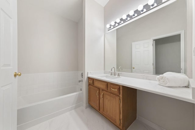 bathroom featuring a washtub and vanity