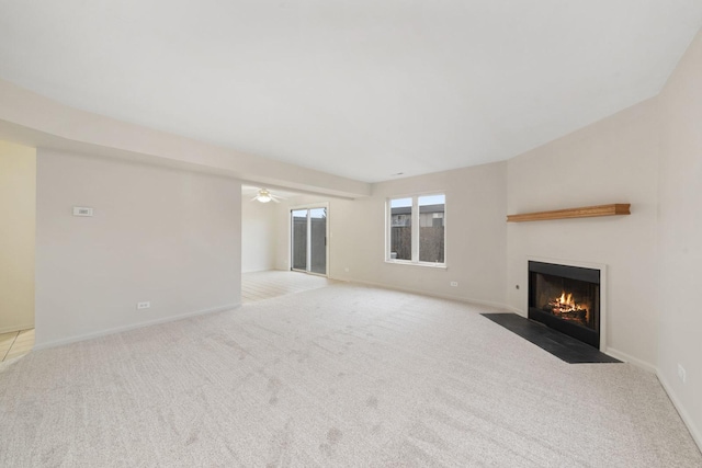 unfurnished living room featuring ceiling fan and light colored carpet