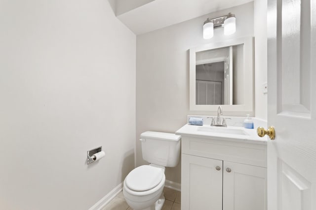 bathroom featuring tile patterned floors, vanity, and toilet