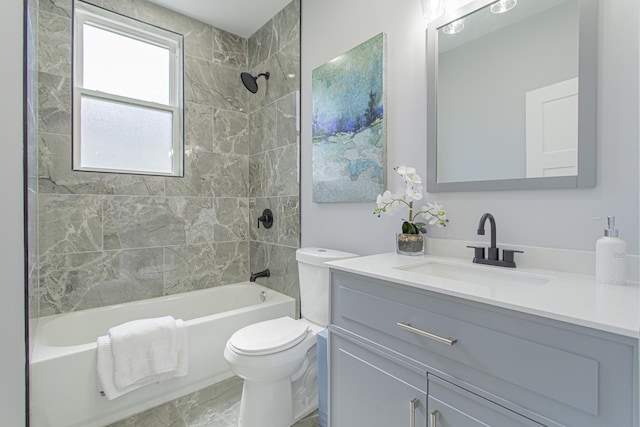 full bathroom featuring vanity, toilet, and tiled shower / bath