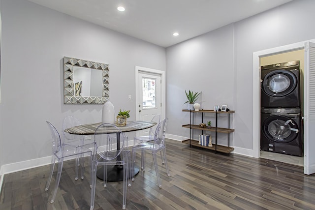 dining room with stacked washer / dryer and dark wood-type flooring