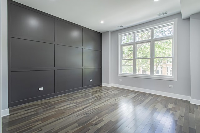 unfurnished room featuring dark wood-type flooring