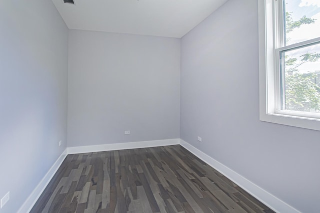 spare room with dark hardwood / wood-style floors