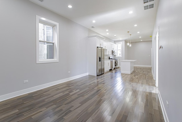 unfurnished living room featuring dark hardwood / wood-style floors