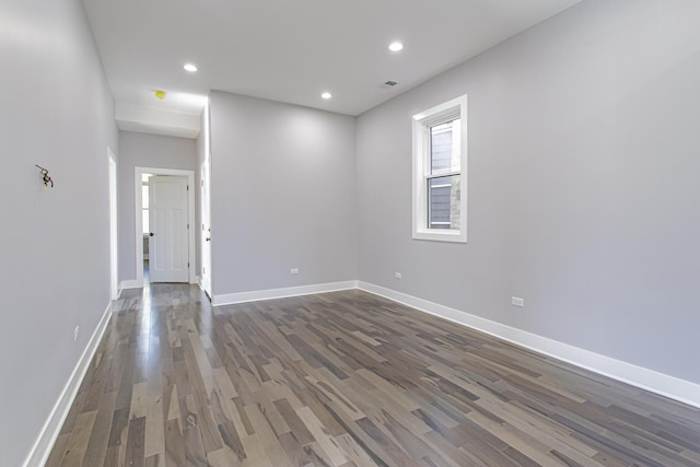 spare room with dark hardwood / wood-style floors