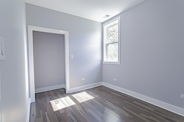 unfurnished room featuring dark hardwood / wood-style flooring