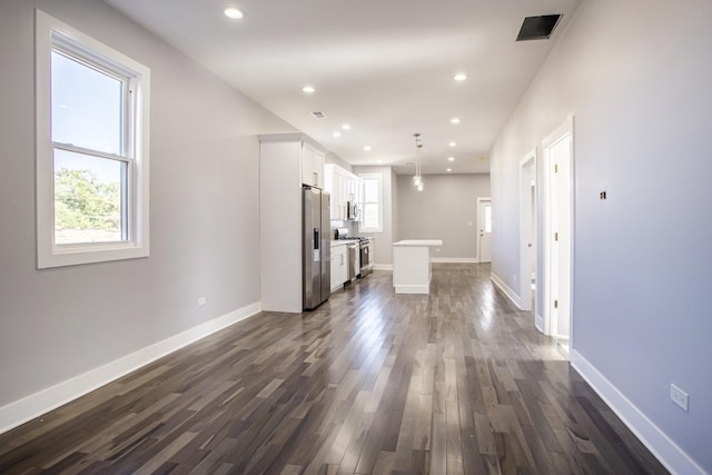 unfurnished living room featuring dark wood-type flooring