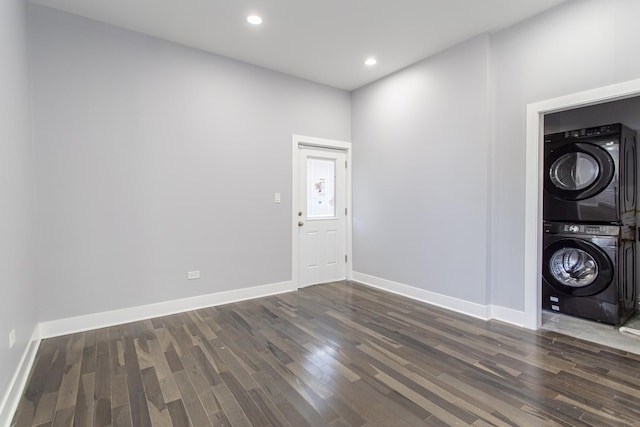 entrance foyer featuring stacked washer / dryer and dark wood-type flooring