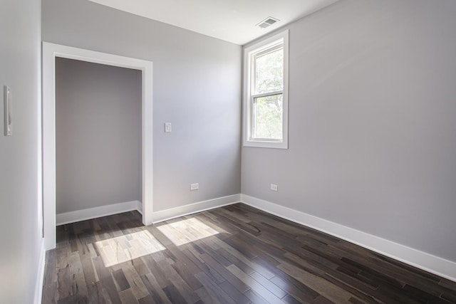 empty room featuring dark hardwood / wood-style flooring