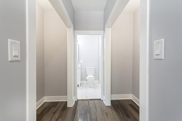 corridor with dark hardwood / wood-style flooring