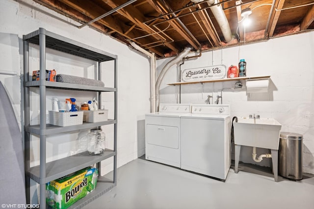 laundry area with washing machine and dryer and sink