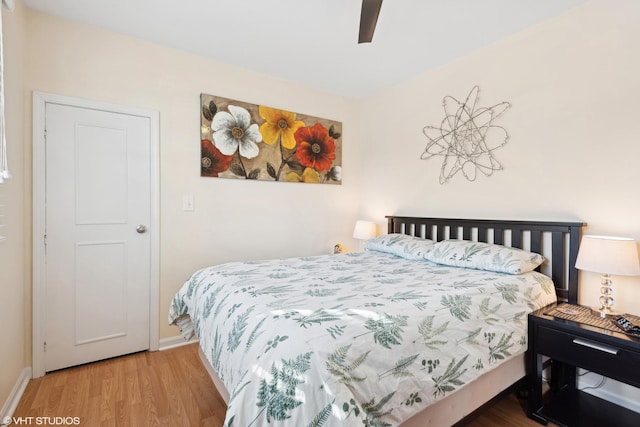 bedroom with wood-type flooring and ceiling fan