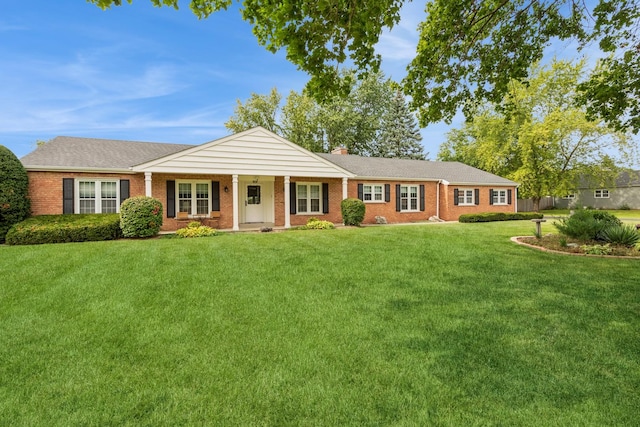 single story home featuring a front lawn