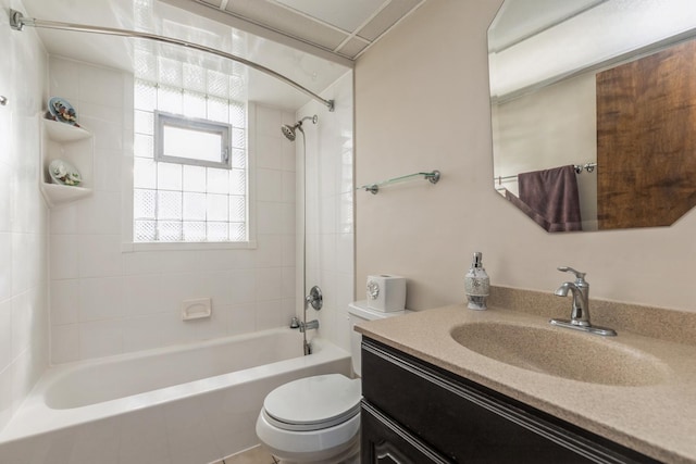 full bathroom featuring vanity, tiled shower / bath combo, and toilet