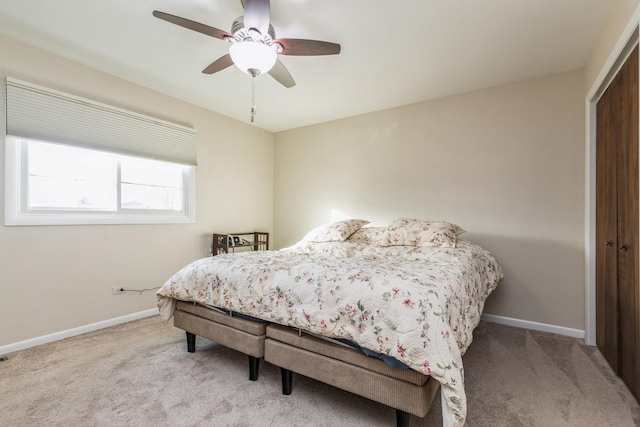 bedroom featuring ceiling fan, a closet, and light carpet