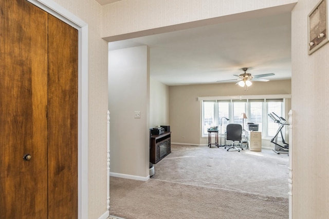 carpeted home office with ceiling fan