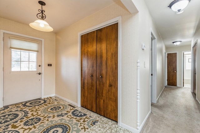 view of carpeted foyer entrance