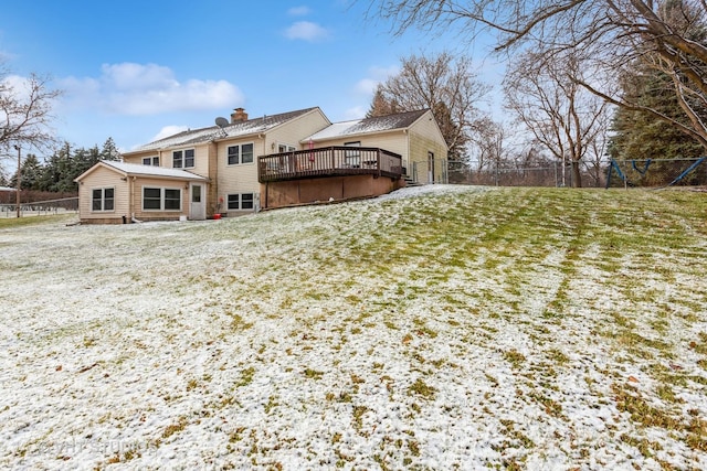 rear view of house with a yard and a deck