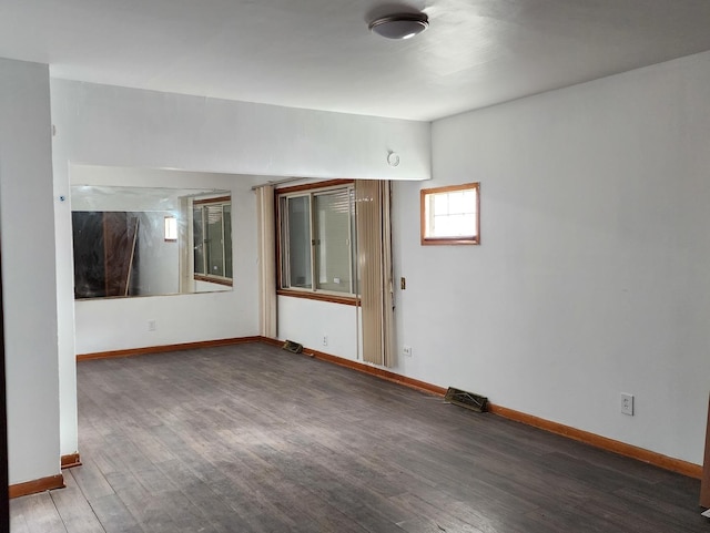 unfurnished room featuring dark wood-type flooring