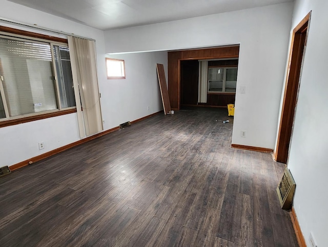 empty room with dark wood-type flooring