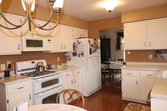 kitchen featuring white cabinetry, dark hardwood / wood-style floors, hanging light fixtures, and white appliances