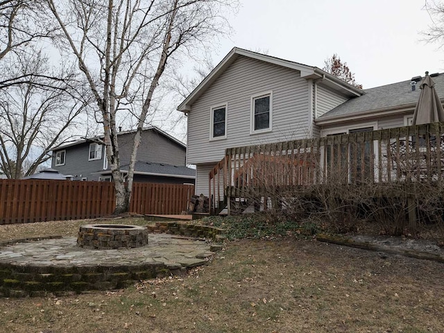 rear view of house featuring a deck, a fire pit, and a patio